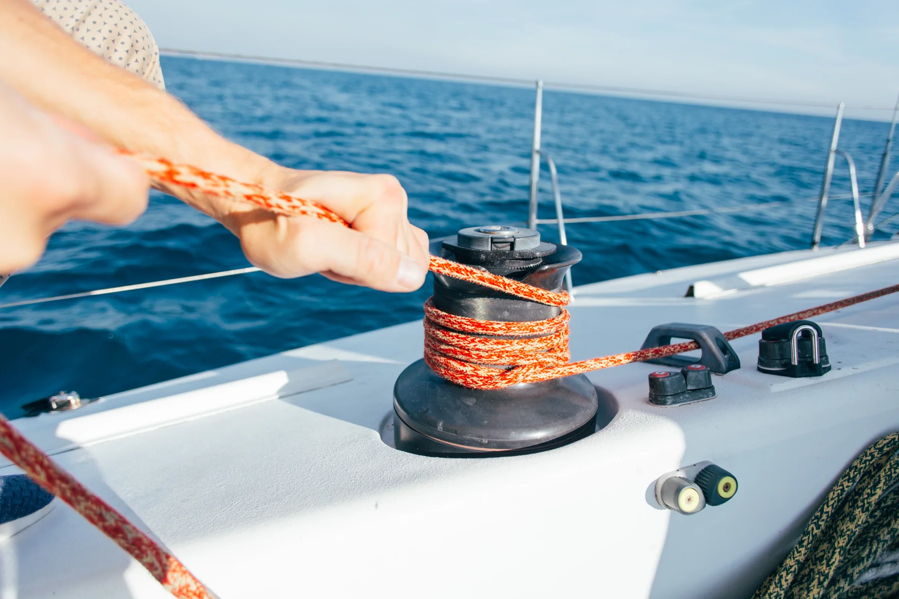 Sailor updating a logbook while relaxing on deck